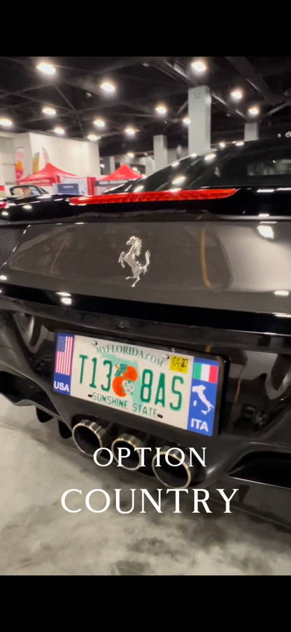 Black Ferrari car with a custom license plate at an USA indoor event.
