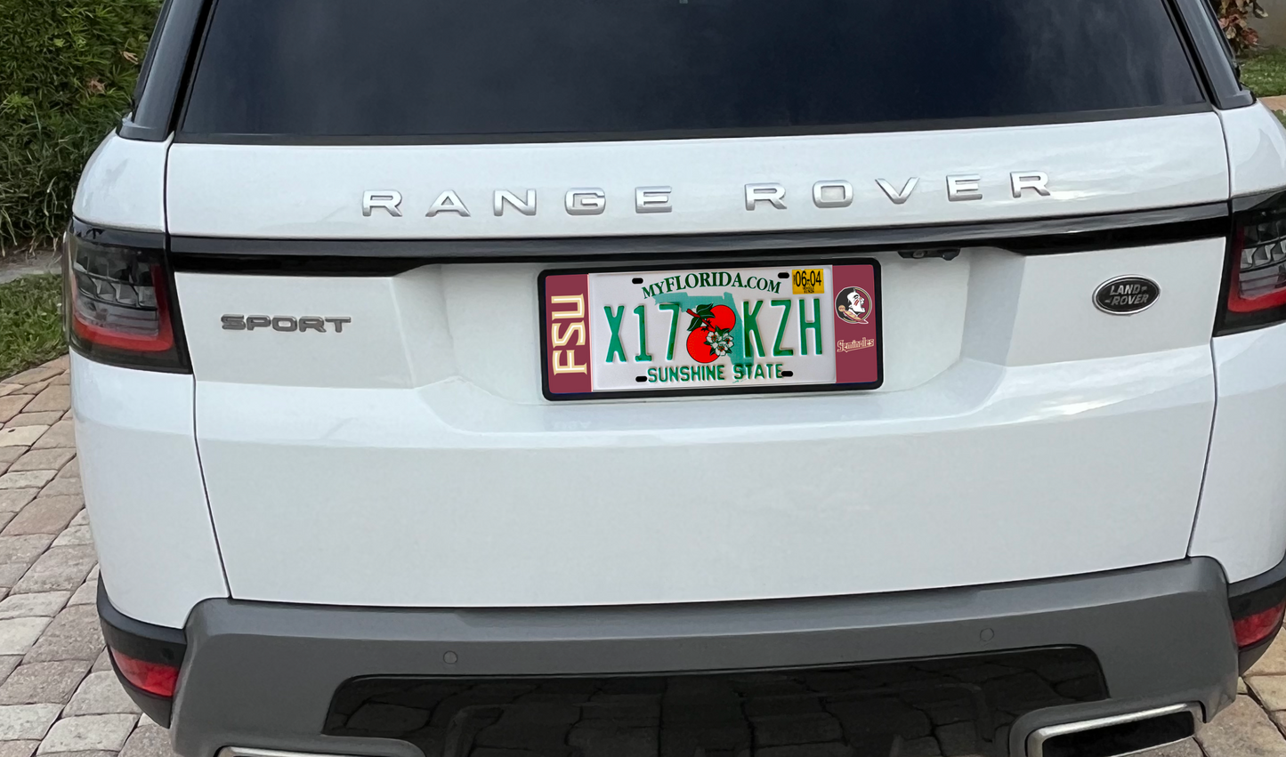 An elongated FSU Seminoles license plate frame mounted on a white Range Rover Sport with a Florida plate.