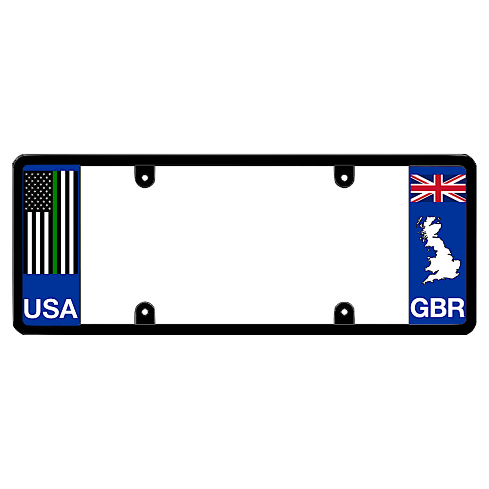 Black license plate frame featuring a thin green line American flag above white USA lettering on the left blue panel, and a British Union Jack flag above a white Great Britain map outline and GBR lettering on the right blue panel