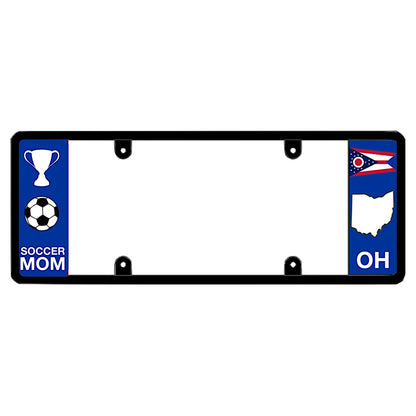 Black license plate frame featuring a blue left panel with a white trophy icon and a soccer ball icon above white Soccer Mom lettering, and an Ohio swallowtail state flag above a white map shape and OH lettering on the right.