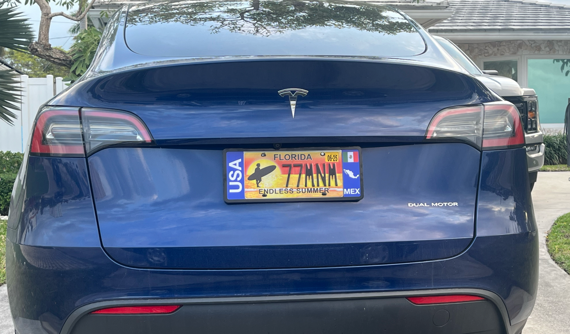 Blue Tesla car with a DFS Mexico Patented license plate frame