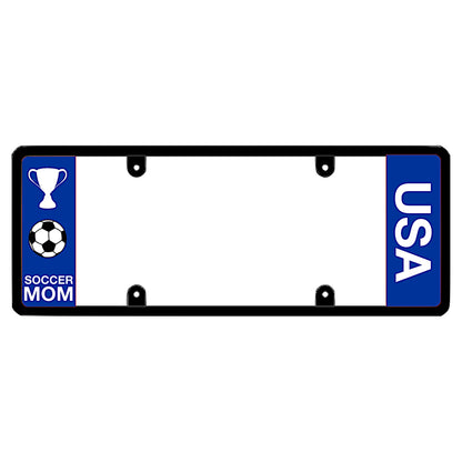 Black license plate frame featuring a blue left panel with a white trophy icon and a soccer ball icon above white Soccer Mom lettering, and a blue right panel with vertical white USA lettering